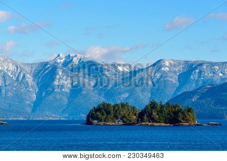 Fantastic view over ocean, snow mountain and rocks at Sechelt inlet in Vancouver, Canada.