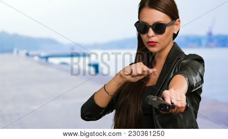 Girl Aiming With Gun at a port
