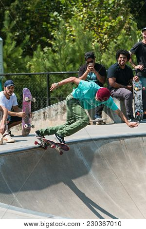 Suwanee, Ga - September 2017:  A Young Adult Skateboarder Drops In At The Bowl As Other Skateboarder