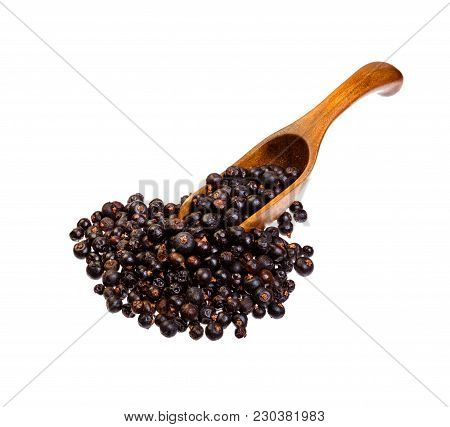 Dried Juniper Berries On The Wooden Spoon. High Resolution Photo.