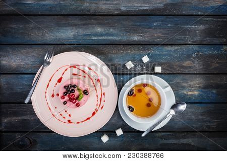 Caramel Cheesecake With Strawberry With Cup Tea And Cutlery On The Wooden Background Top View