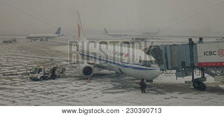 Airplane At The Airport In A Snow Storm