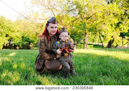 Mom And Son In A Military Soviet Soldier Uniform With St. George Ribbons Against The Backdrop Of Nat
