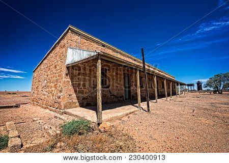 Australia Outback desert with an old abandoned vintage railway station near the old Ghan under blue sky 