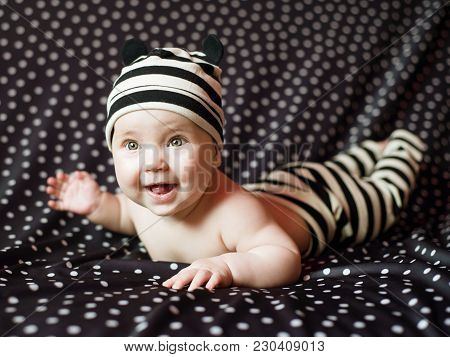 Portgait Of Little Baby Girl On Black In Peas Background.
