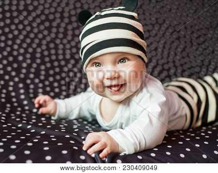 Portgait Of Little Baby Girl On Black In Peas Background.