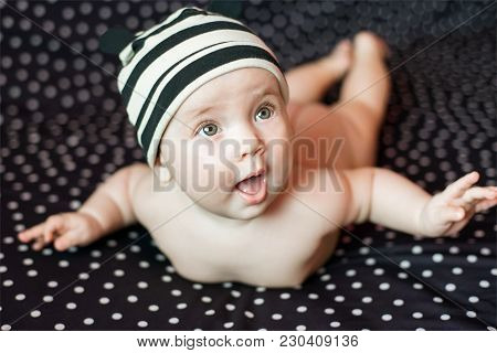 Portgait Of Little Nacked Baby Girl On Black In Peas Background.