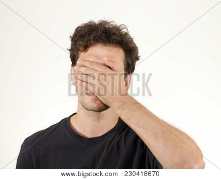 Man With Curly Hair Closing His Eyes By Hands
