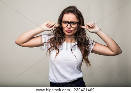 Close Up Portrait Of Angry Stressed Out Young Woman Plugging Ears With Fingers And Closing Eyes Tigh