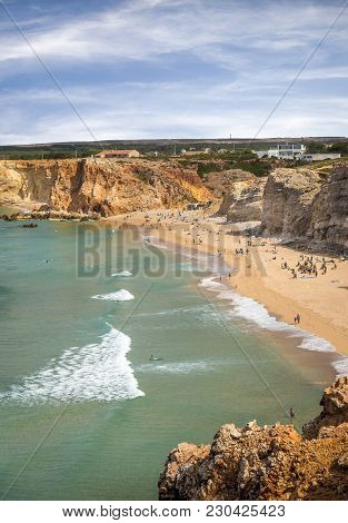SAGRES, PORTUGAL - AUGUST 25, 2016: Aerial view of surfers on sandy beach near Sagres village in Portugal
