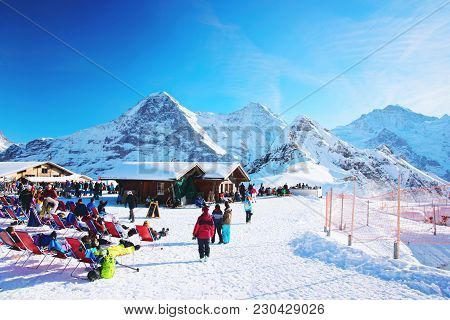 Mannlichen, Switzerland - December 31, 2013: Mannlichen Mountain And Resort With Tourists At Winter 