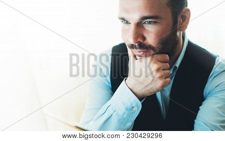 Bearded Young Businessman Working On Modern Office At Night. Consultant Man Thinking Looking In Moni
