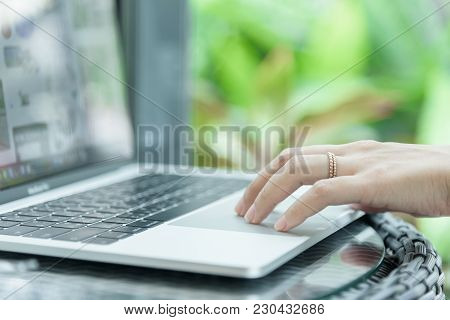 Asian Woman Hands And Married Ring Has Touching And Typing On Laptop Computer With Blurred Coffee, C
