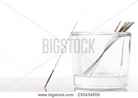 Silver Needles For Traditional Chinese Medicine Acupuncture. Close-up. White Background. There Is So
