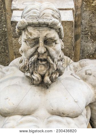 Atlas Statue Holding A Portico. Stone Sculptures Of Male Torsos