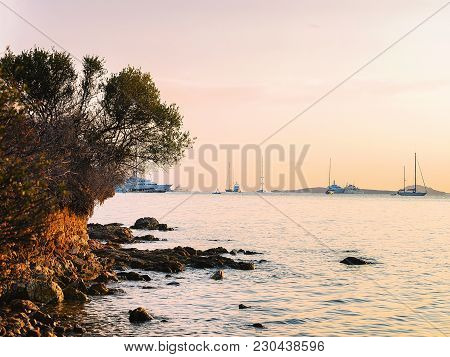 Sunrise With Yachts And Ships In Porto Rotondo On Costa Smeralda At Mediterranean Sea, Sardinia, Ita