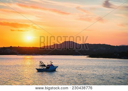 Sunrise With Ship At Porto Rotondo In Costa Smeralda At Mediterranean Sea, Sardinia, Italy