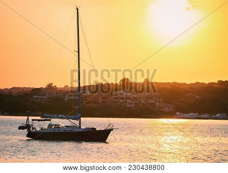 Sunrise With Boat At Costa Smeralda At Mediterranean Sea, Sardinia, Italy
