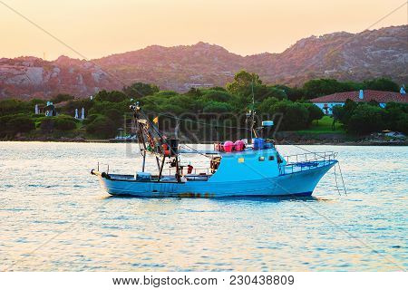 Sunrise With Boat In Costa Smeralda At Mediterranean Sea, Sardinia, Italy