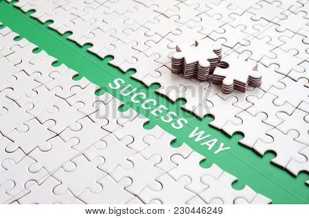 Success Way. The Green Path Is Laid On The Platform Of A White Folded Jigsaw Puzzle. The Missing Ele