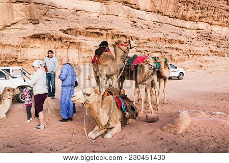 Wadi Rum, Jordan - December, 25, 2017: Tourists And Bedouins Near Camals In Wadi Rum Desert In Jorda