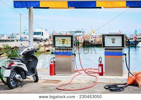 Motorcycle At Petrol Station For Filling Ships At Cefalu Port, Palermo Region, Sicily Island In Ital