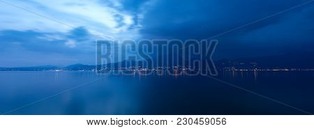 Lake Garda At Night (lago Di Garda) The Largest Italian Lake Of Glacial Origin With The Lights Of Th