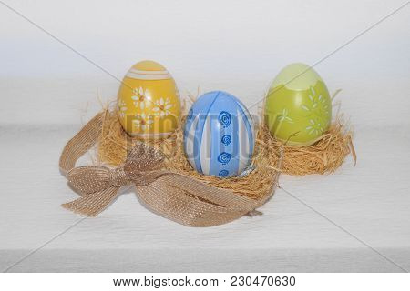 Easter Eggs,straw And Bow-knot On A White Background