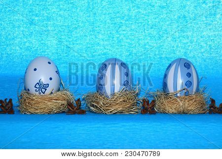 Easter Eggs,straw And Bow-knot On A Blue Background