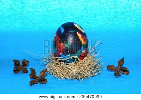 Easter Egg,straw And Bow-knot On A Blue Background