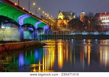 Slasko-dabrowski Bridge In Old Town With Reflection In The Vistula River During Evening Blue Hour, W