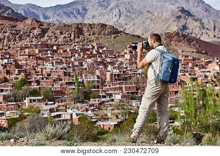 Abyaneh,  Isfahan Province, Iran - April 26, 2017: One Tourist Of Caucasian Appearance, With A Backp