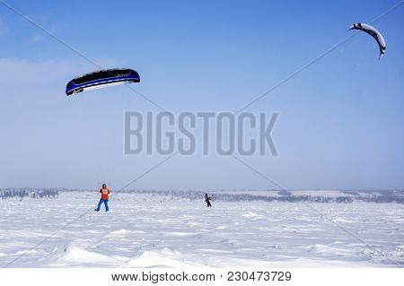 Perm, Russia - March 09, 2018: Snowkiters Rides On The Ice Of The Kama Reservoir