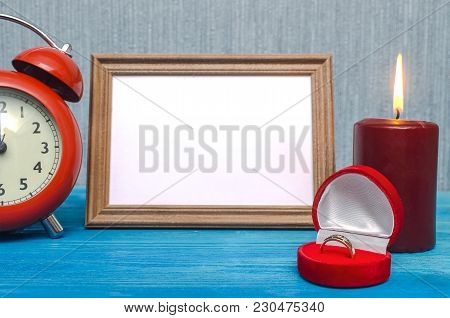 Wedding Ring In A Gift Present Box And Empty Photo Frame Of A Loved One Copy Space And Red Alarm Clo
