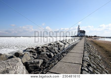 The Island Of Marken In Winter With Ice Sculptures And Lighthouse