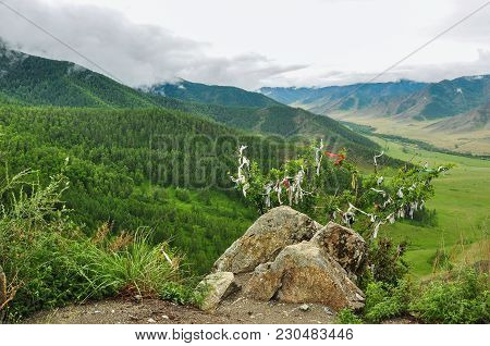 Stone And Bush, Hung With Ribbons Against The Landscape Of A Mountain Valley. Chike-taman Road Pass,