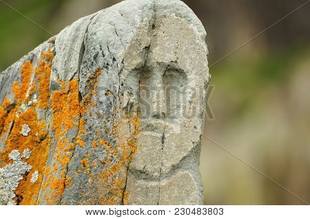 A Human Face Carved On A Ritual Idol Stone. Altai, Russia.
