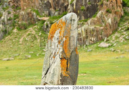 A Human Face Carved On A Ritual Idol Stone. Altai, Russia.