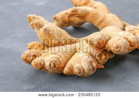 Spicy Root Of Ginger On A Wooden Table