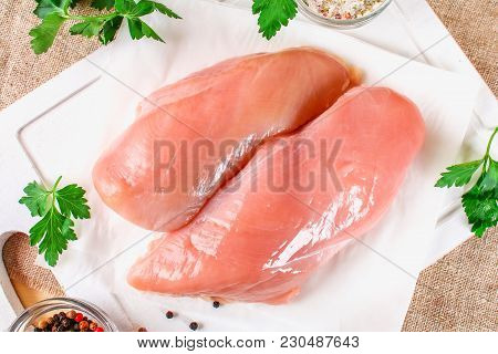 Raw Chicken Fillets On Wooden Cutting Board