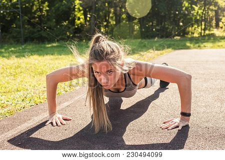 Fitness Woman Doing Push-ups During Outdoor Cross Training Workout. Beautiful Young And Fit Fitness 