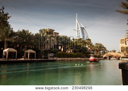DUBAI, UAE - FEBRUARY, 2018: View on Burj Al Arab, the world only seven stars hotel seen from Madinat Jumeirah, a luxury resort which include hotels and souk spreding across over 40 hectars.