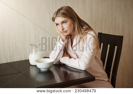 Daughter Is Fed Up Of Same Breakfast Every Day. Shot Of Bothered And Annoyed Young Woman In Nightwea