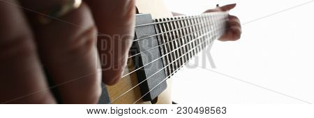 Male Hands Playing Electric Guitar On Maple Fretboard Closeup Photo. Learning Musical Instrument Tra