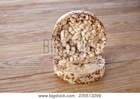 Stack Of Diet Crispbreads On Light Wooden Table, Close-up, Selective Focus. Composition Of Puffed Ri