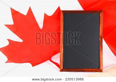 Blackboard With The National Flag Of Canada Drawn On And A Chalk