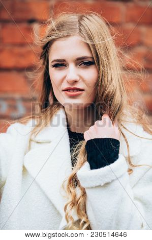 Beautiful Girl In Autumn Garden In A White Coat