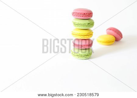 Three Different Types Of Macaroons Colors Pink, Green And Yellow Isolated On White Background With C