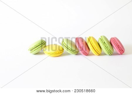 Three Different Types Of Macaroons Colors Pink, Green And Yellow Isolated On White Background With C