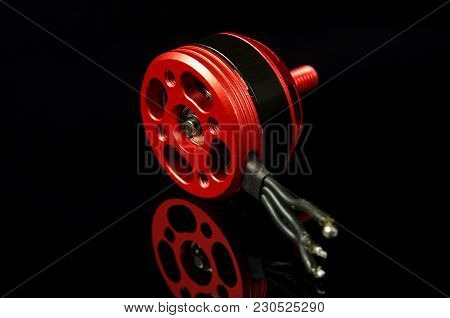 Brushless Motor With Wires Isolated On The Black Reflective Background